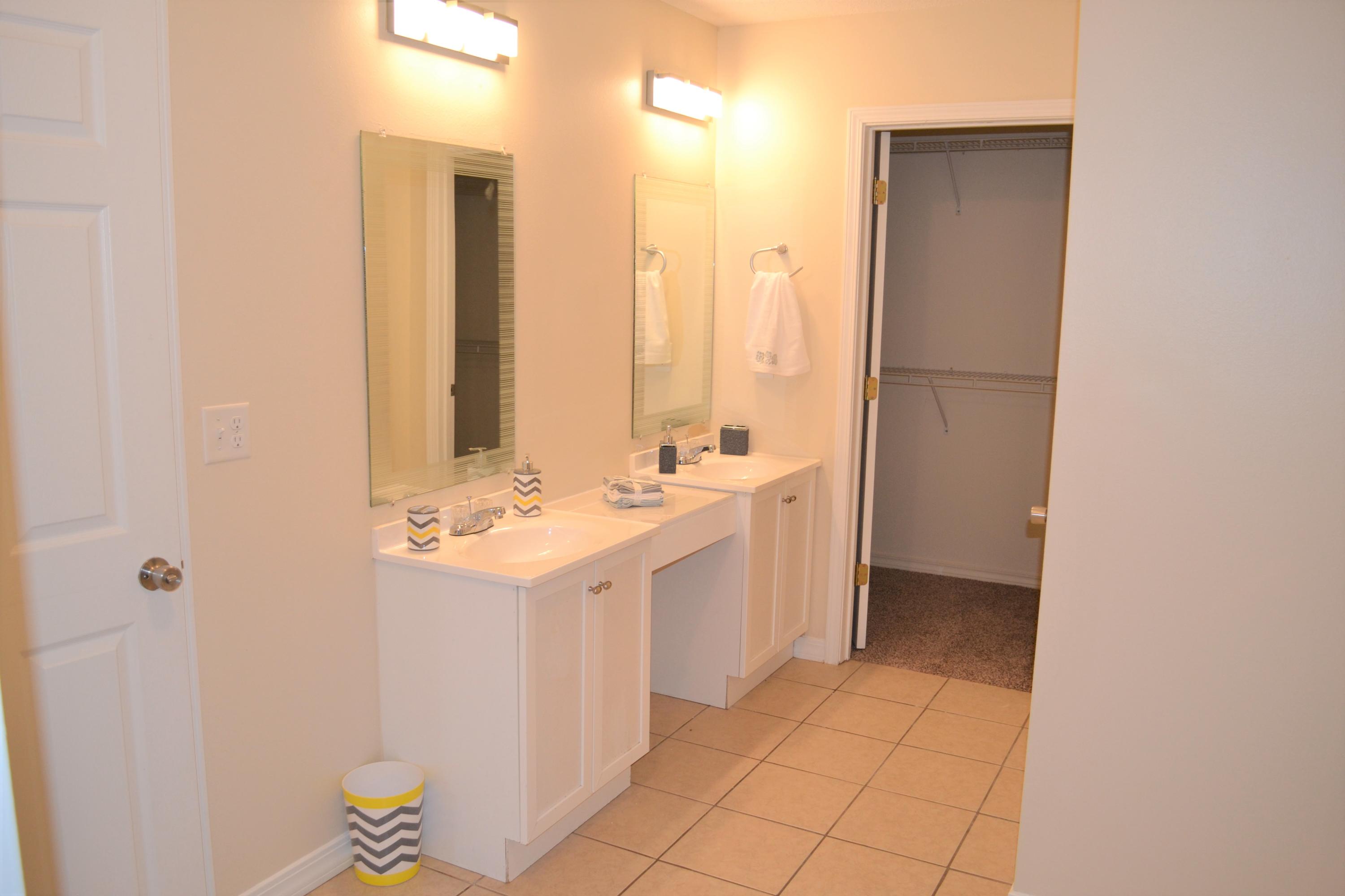 5237 Kervin Road Crestview, FL 32539 - Photo 23 of 28 a bathroom with a sink a mirror and a shower