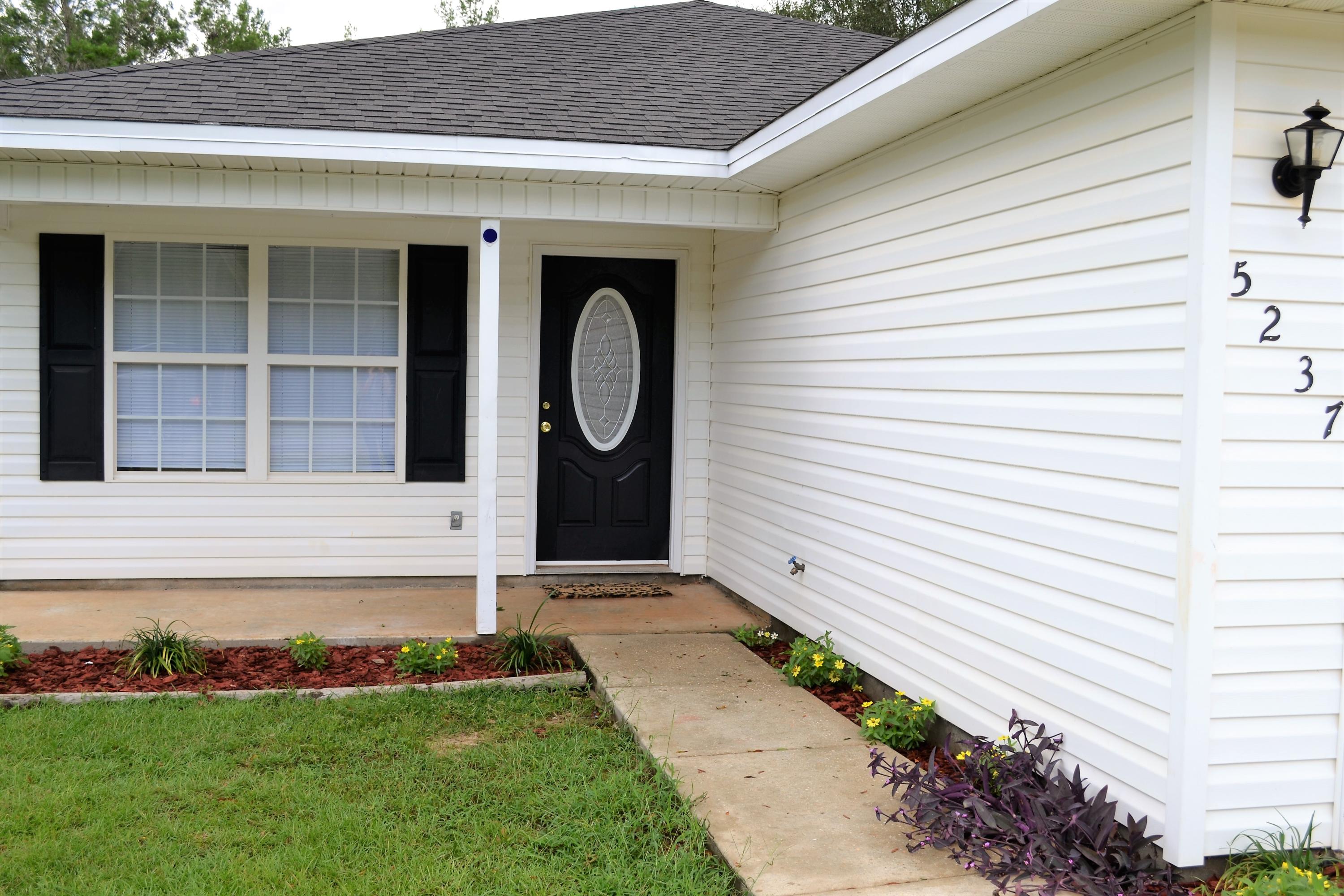 5237 Kervin Road Crestview, FL 32539 - Photo 26 of 28 a front view of a house with garden