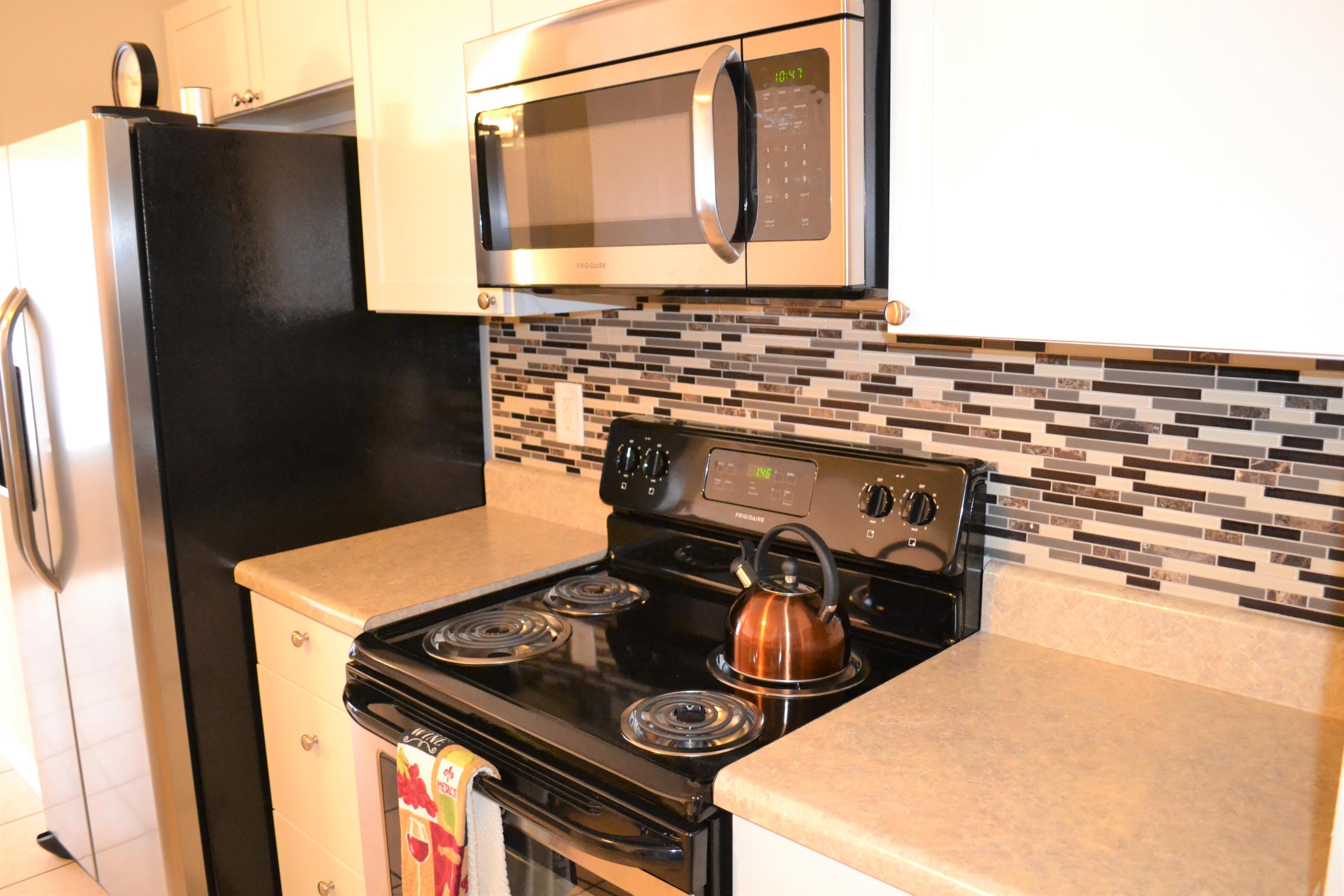 5237 Kervin Road Crestview, FL 32539 - Photo 8 of 28 a kitchen with a stove and a refrigerator