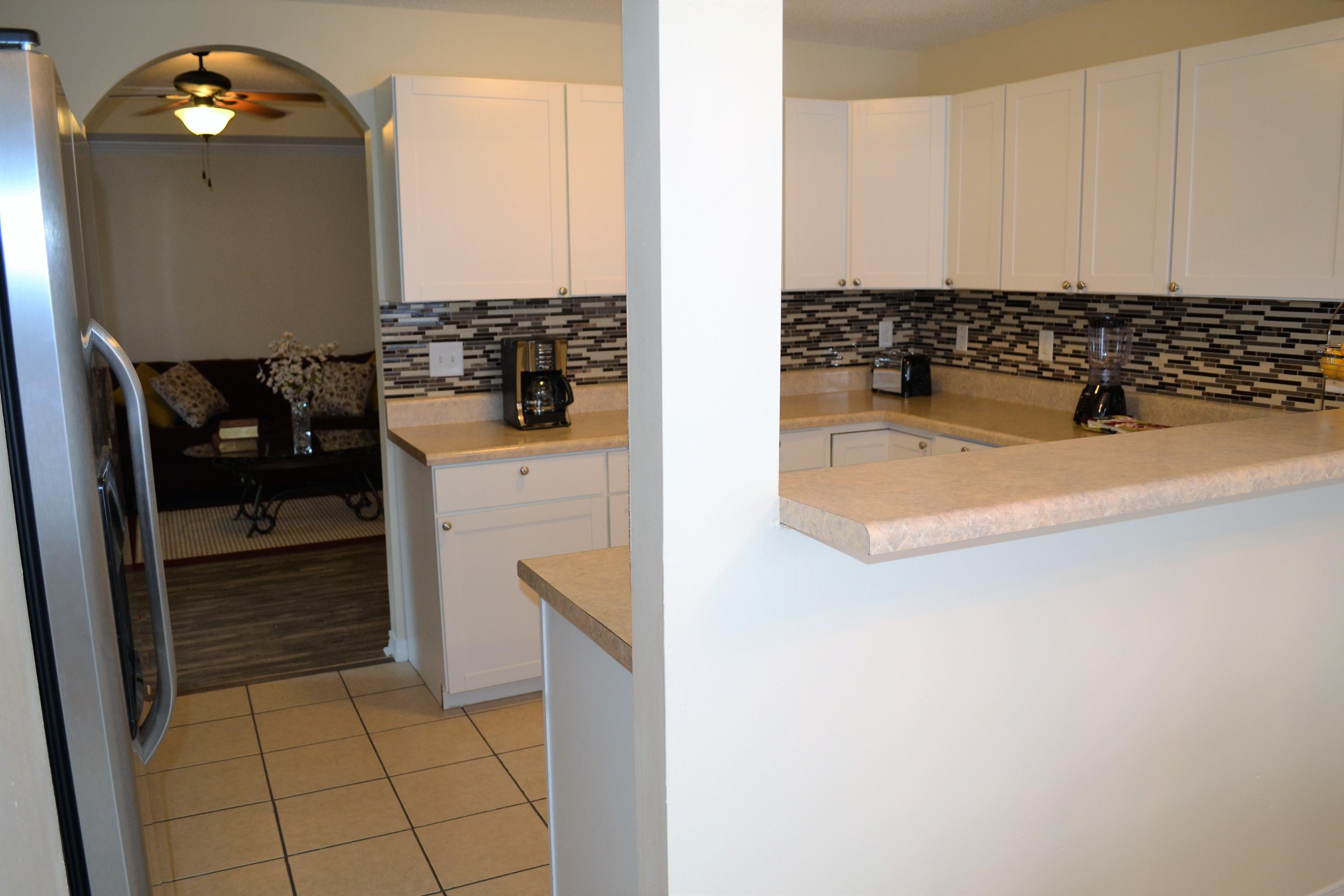 5237 Kervin Road Crestview, FL 32539 - Photo 10 of 28 a kitchen with a sink a stove and cabinets
