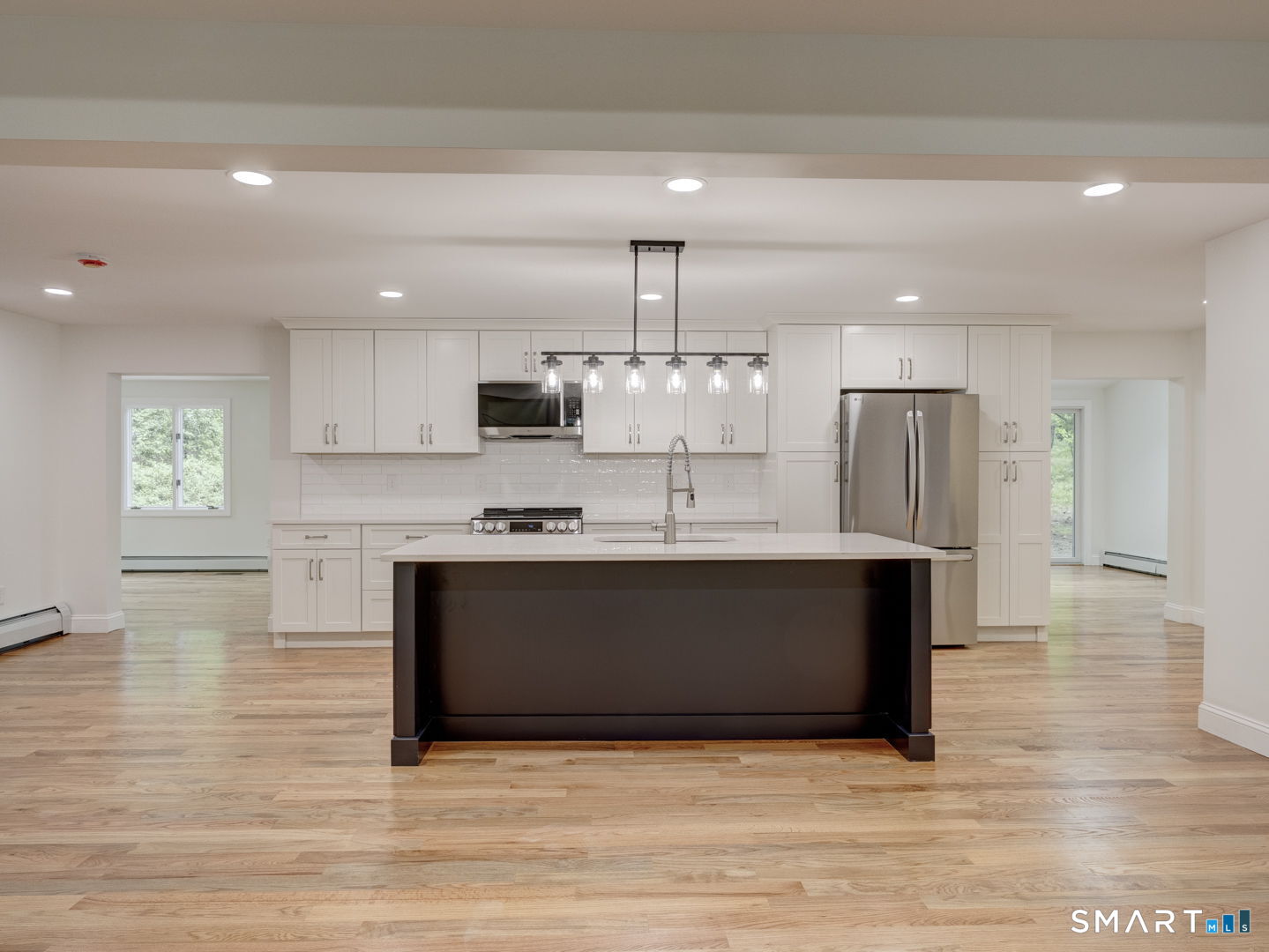 243 Brickyard Road Farmington, CT 06032 - Photo 1 of 34 Beautiful white cabinetry, subway tile backsplash, large island, and white mikasa cararra quartz counter