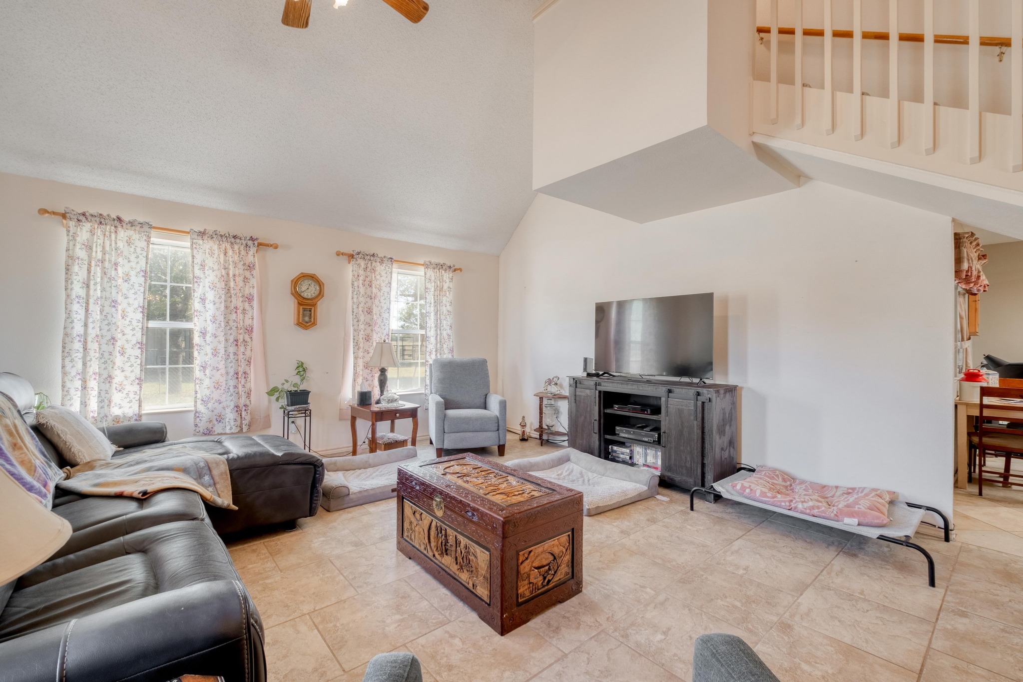 153 Pleasant Grove Road Elgin, TX 78621 - Photo 7 of 34 Living room with a ceiling fan, high vaulted ceiling, and light tile patterned flooring