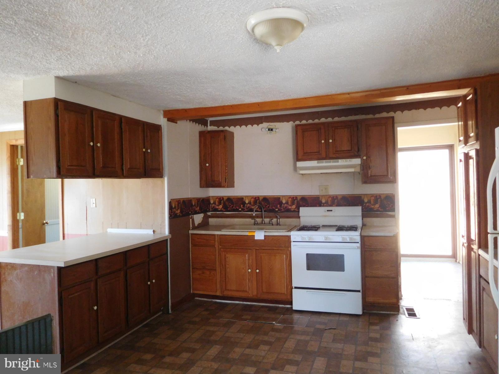 2201 Pondtown Road Chestertown, MD 21620 - Photo 5 of 9 a kitchen with a stove and a microwave