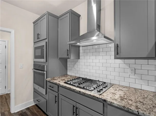 a kitchen with granite countertop a stove and a refrigerator