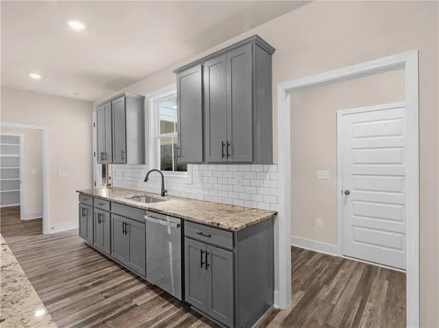 a kitchen with a sink and wooden cabinets