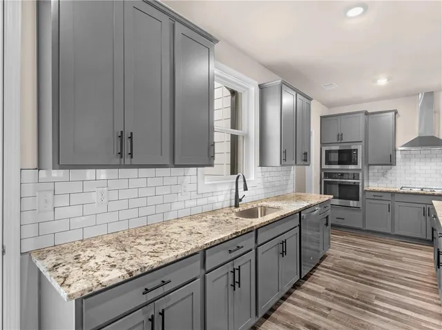a spacious bathroom with a granite countertop sink and a mirror