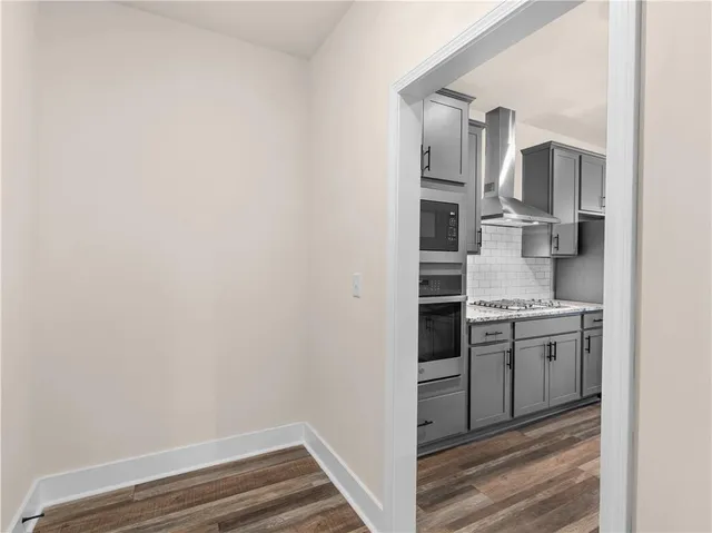 a kitchen with cabinets and stainless steel appliances