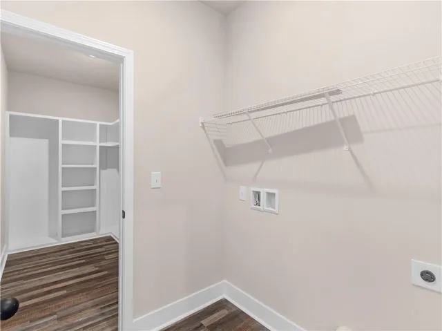 a view of walk in closet with empty racks