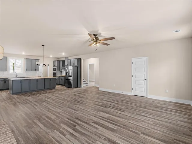 a view of an empty room with a kitchen