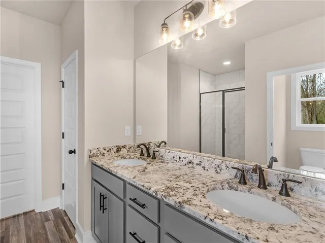 a bathroom with double vanity sinks and a mirror