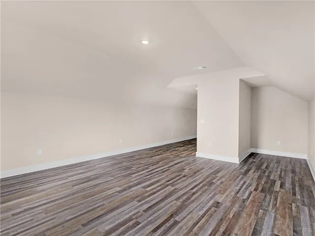a view of an empty room and wooden floor