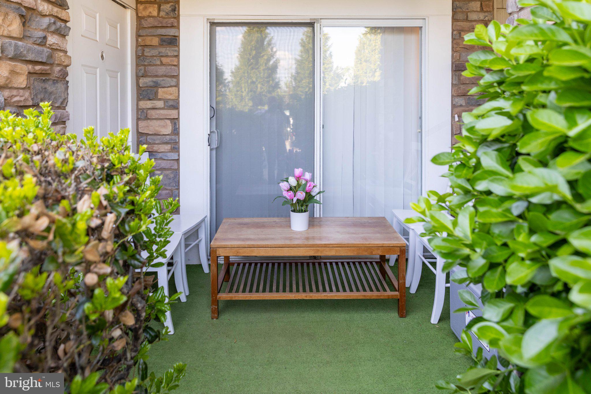 12824 Clarksburg Square Road, Unit 105 Clarksburg, MD 20871 - Photo 93 of 96 Charming patio oasis with greenery.