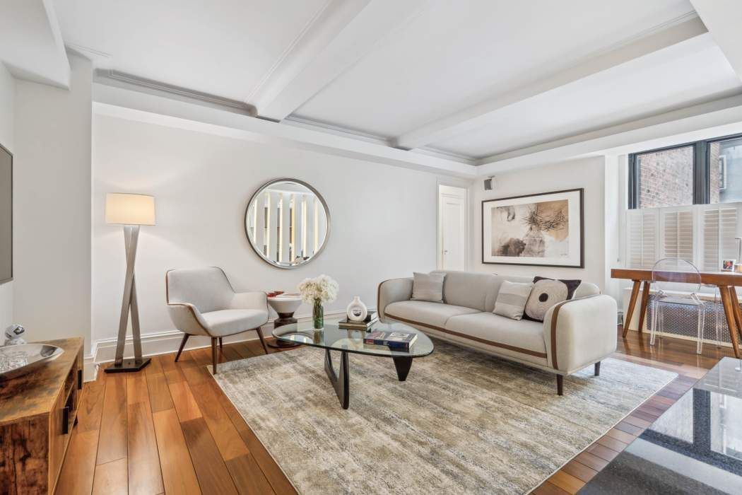 333 East 53rd Street, Unit 1J Manhattan, NY 10022 - Photo 1 of 15 a living room with furniture a rug and wooden floor