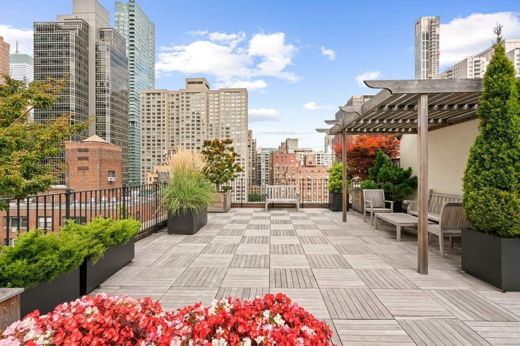 333 East 53rd Street, Unit 1J Manhattan, NY 10022 - Photo 10 of 15 a view of a city with tall buildings