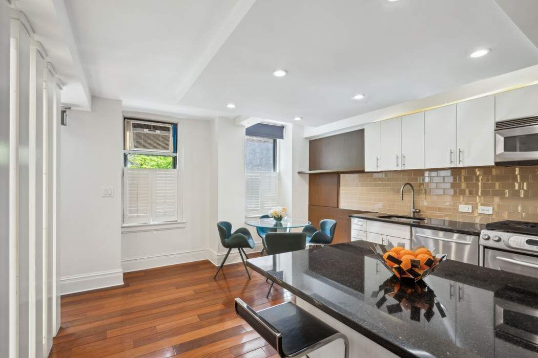 333 East 53rd Street, Unit 1J Manhattan, NY 10022 - Photo 9 of 15 a living room with furniture and wooden floor