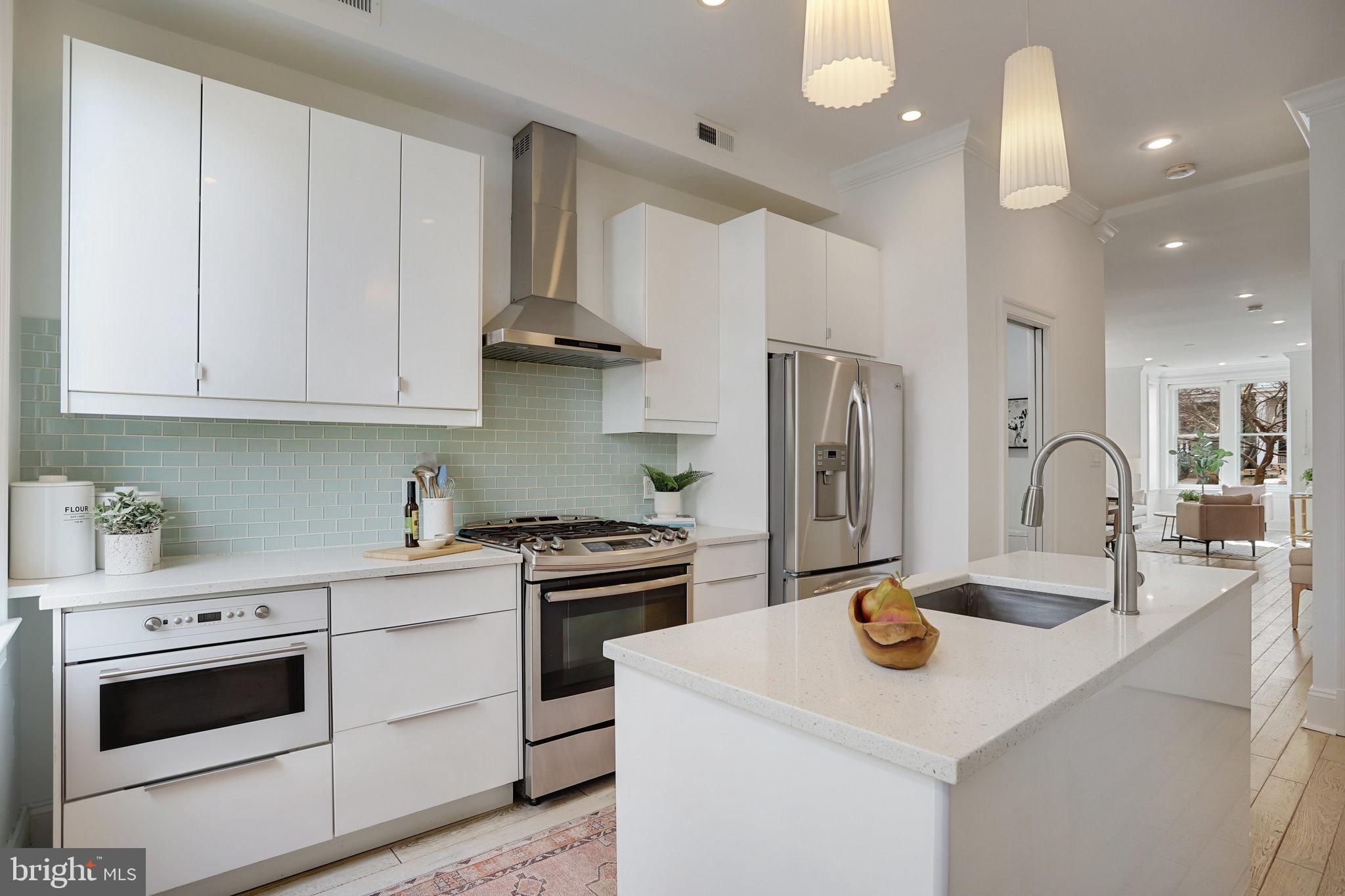 1322 E Street Northeast Washington, DC 20002 - Photo 14 of 49 a kitchen with stainless steel appliances granite countertop a sink stove and refrigerator