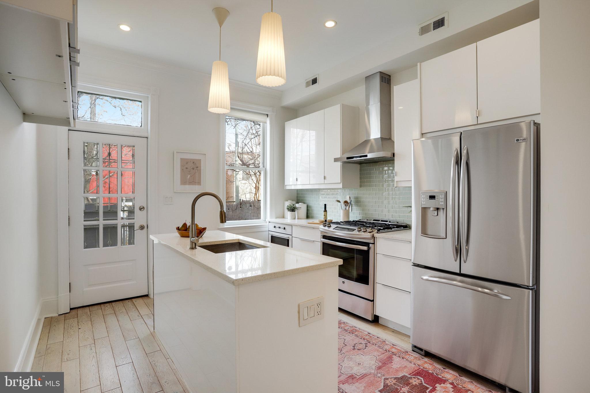 1322 E Street Northeast Washington, DC 20002 - Photo 15 of 49 a kitchen with stainless steel appliances granite countertop a refrigerator sink and stove