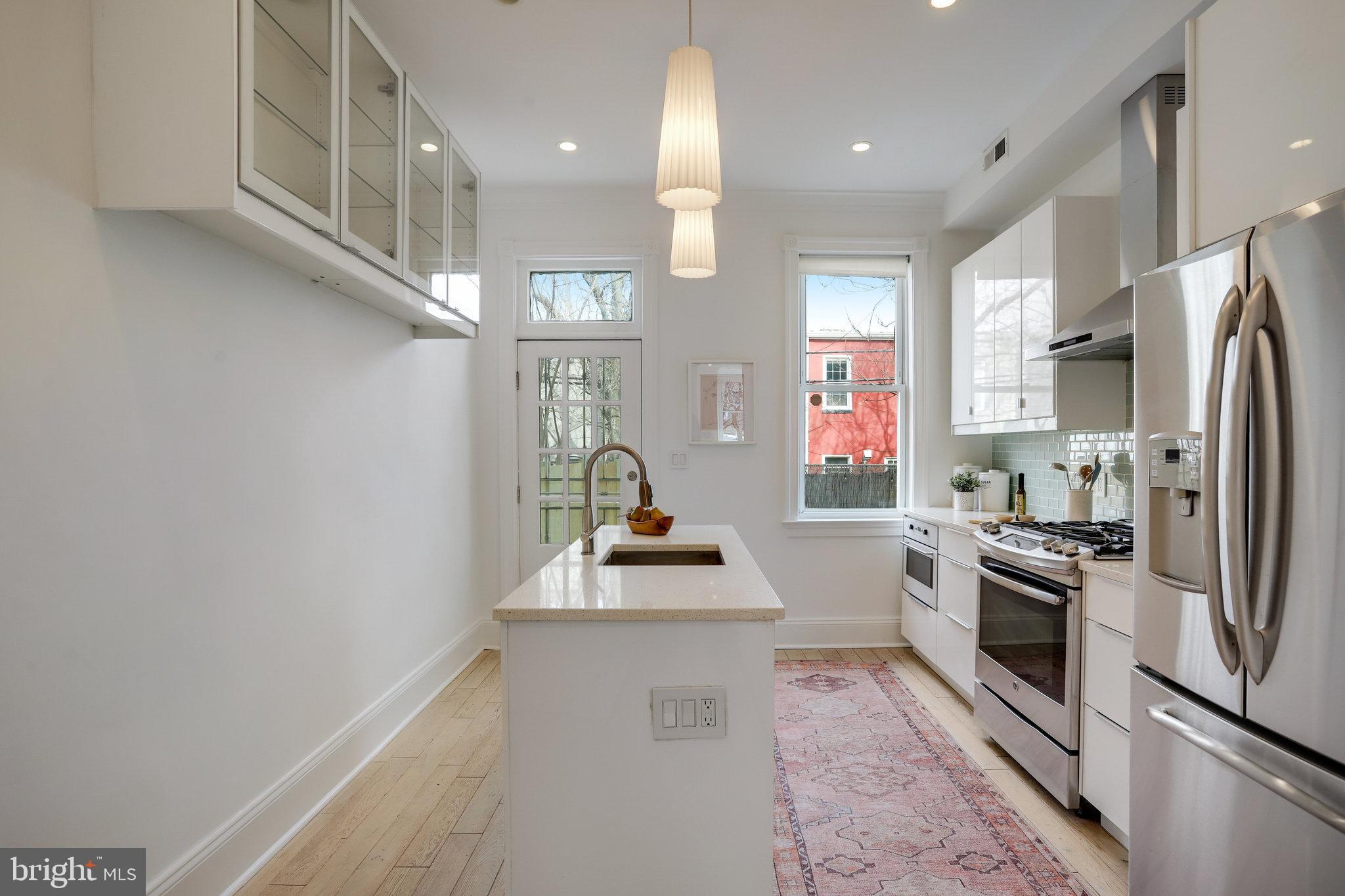 1322 E Street Northeast Washington, DC 20002 - Photo 16 of 49 a kitchen with stainless steel appliances a refrigerator sink and stove