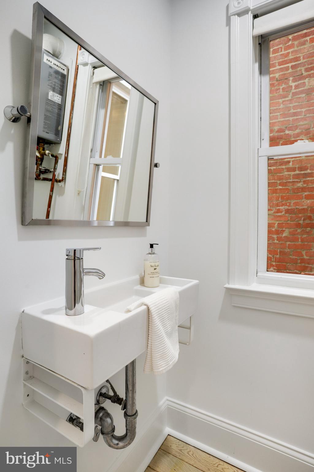 1322 E Street Northeast Washington, DC 20002 - Photo 19 of 49 a bathroom with a sink and a mirror