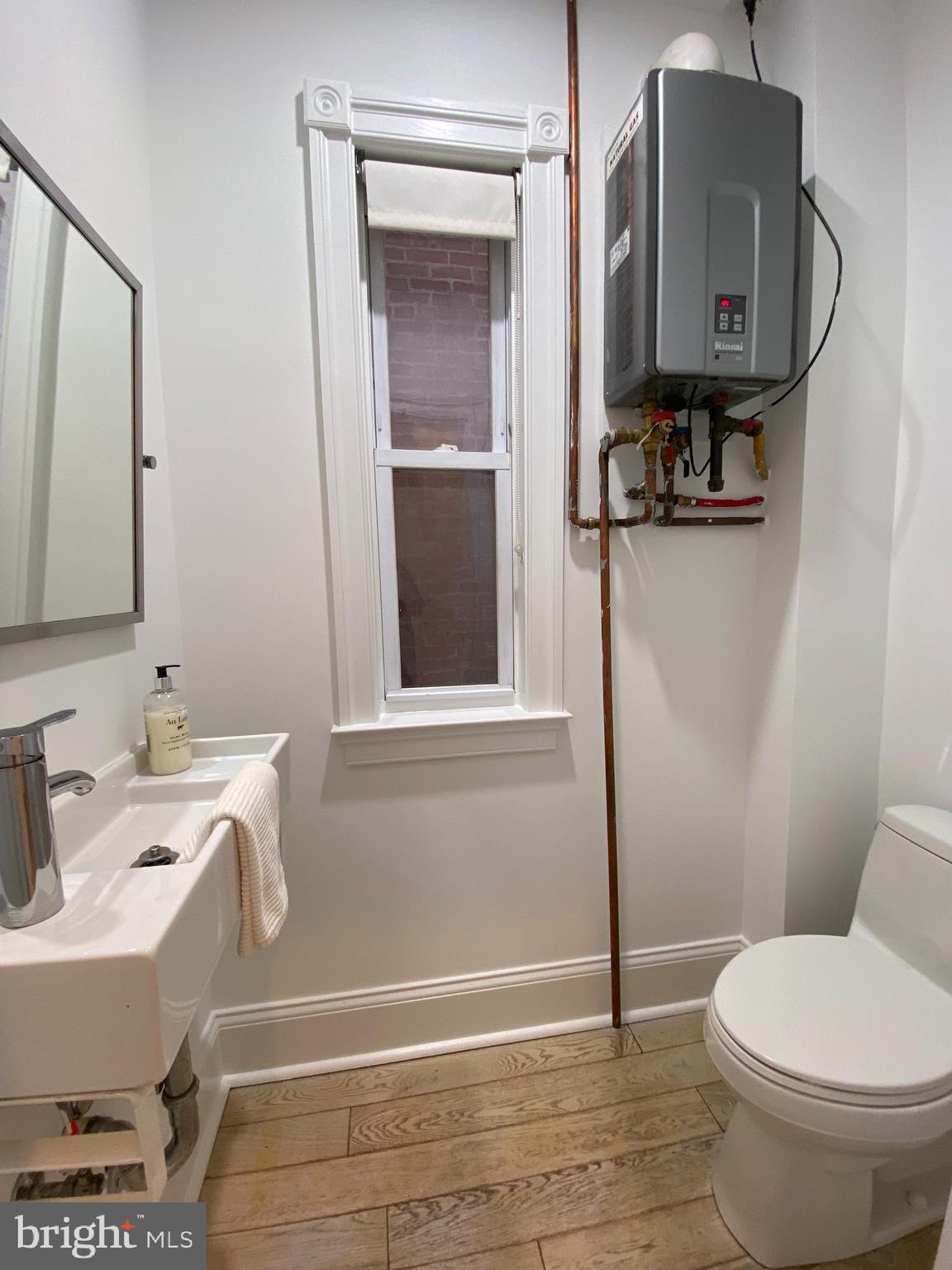 1322 E Street Northeast Washington, DC 20002 - Photo 20 of 49 a bathroom with a toilet sink and mirror