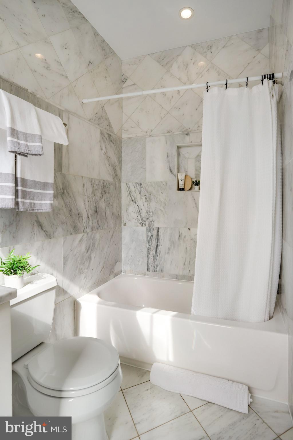 1322 E Street Northeast Washington, DC 20002 - Photo 28 of 49 a white bath tub sitting next to a white toilet