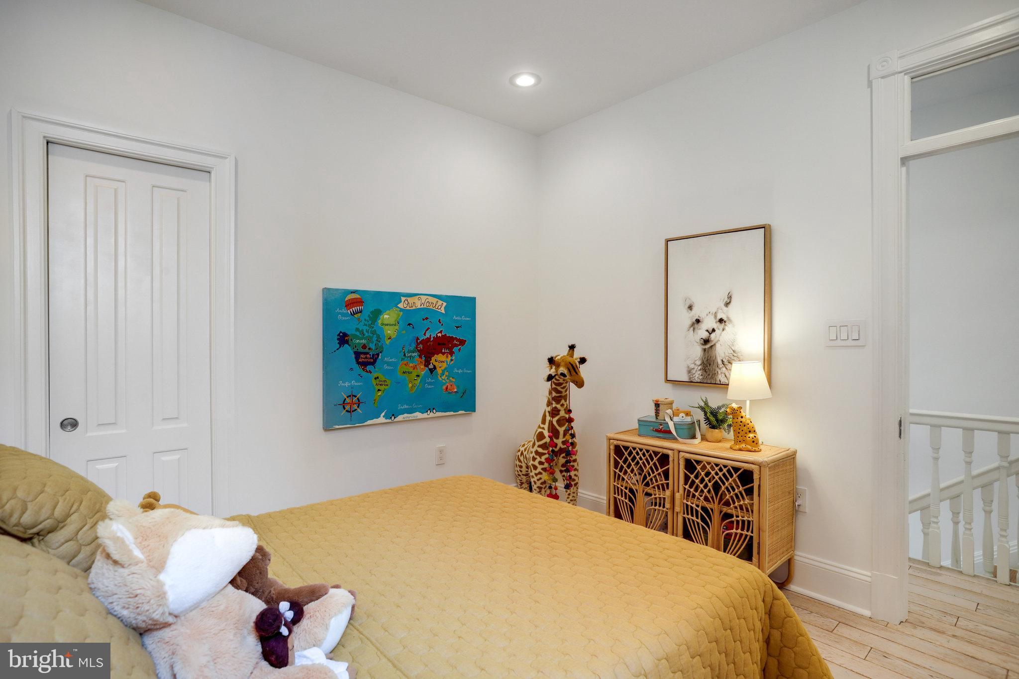 1322 E Street Northeast Washington, DC 20002 - Photo 32 of 49 a bed room with a bed and a painting on the wall