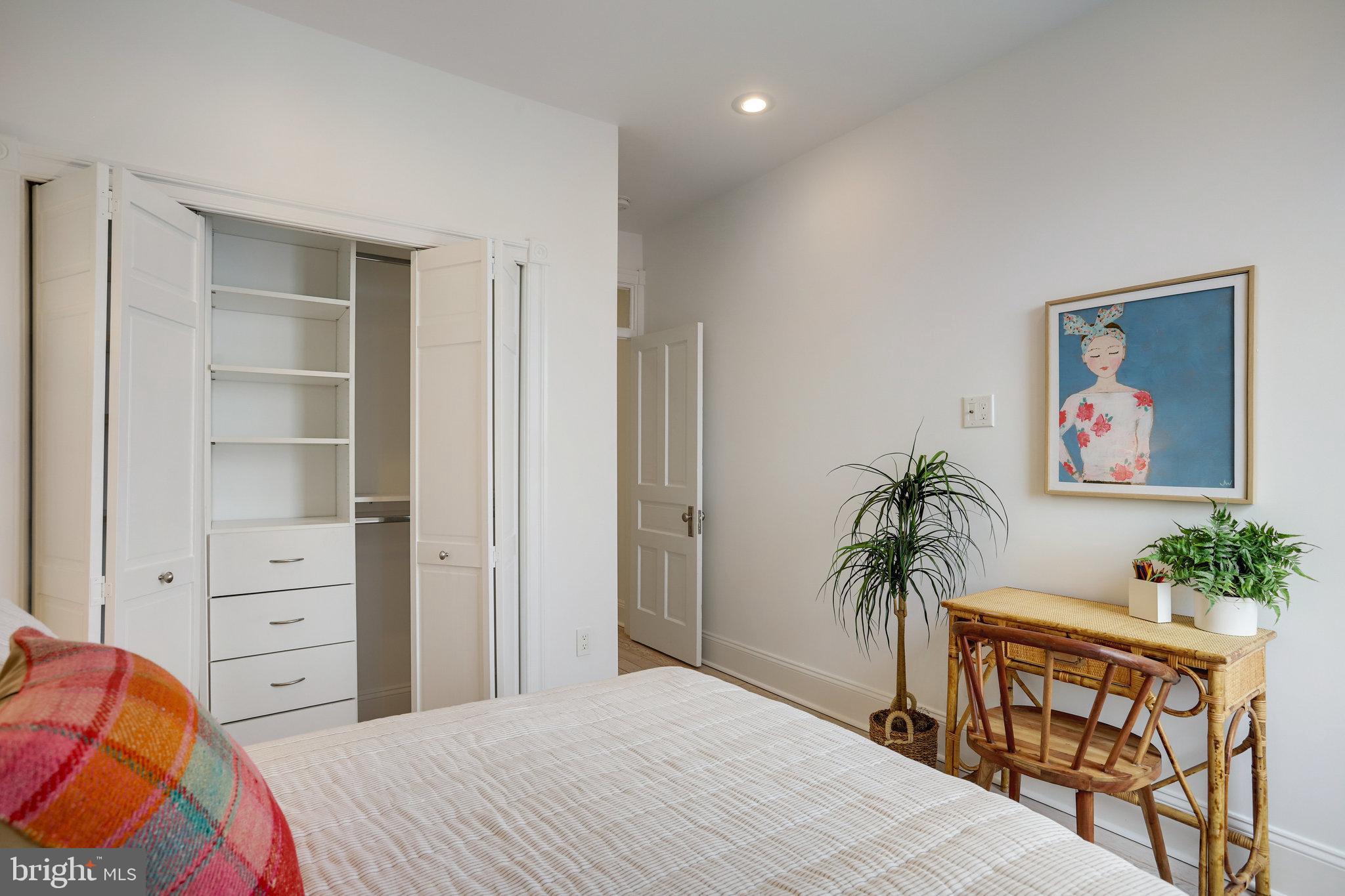 1322 E Street Northeast Washington, DC 20002 - Photo 39 of 49 a bedroom with a bed and a potted plant