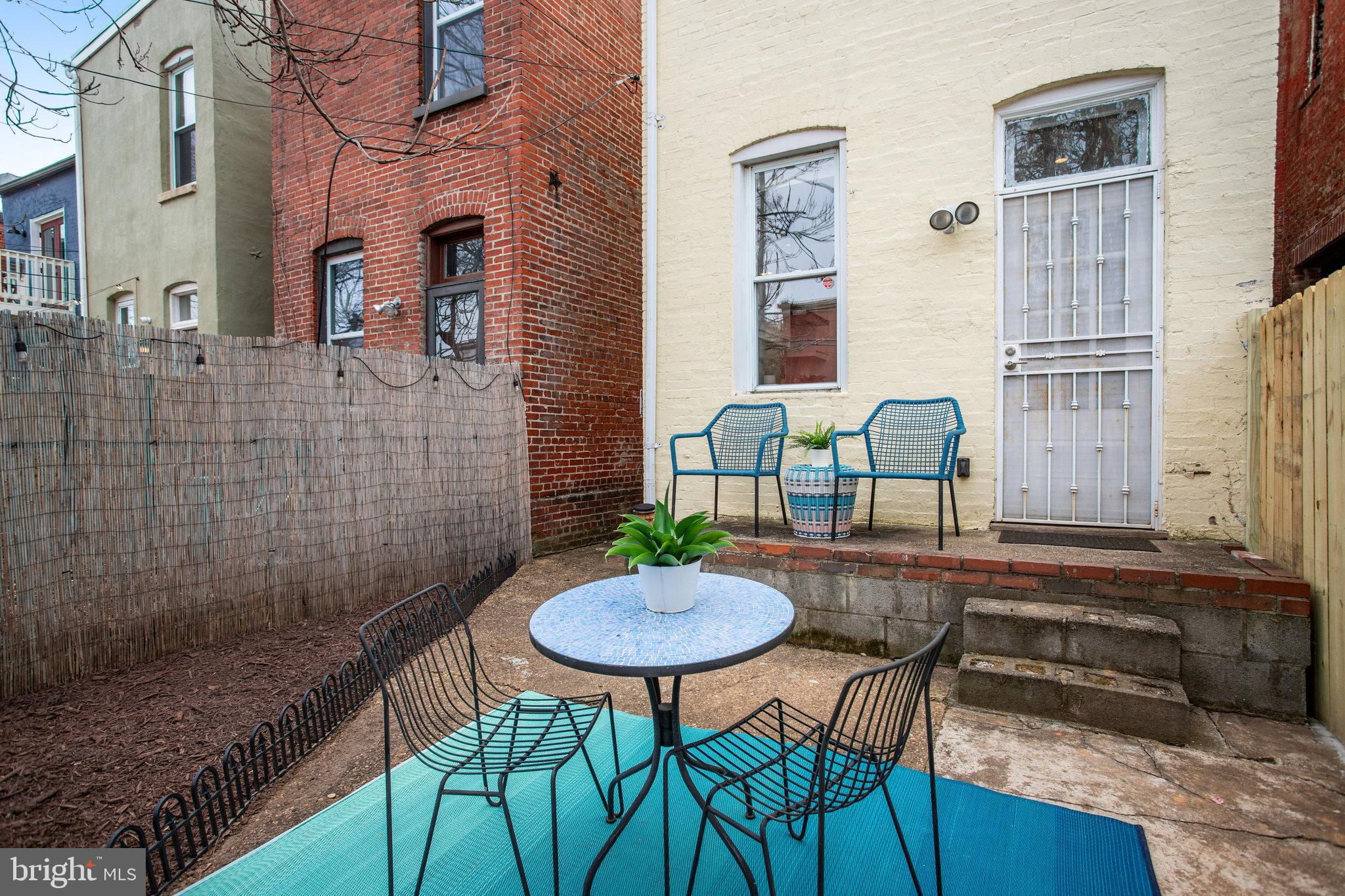 1322 E Street Northeast Washington, DC 20002 - Photo 40 of 49 a backyard of a house with table and chairs