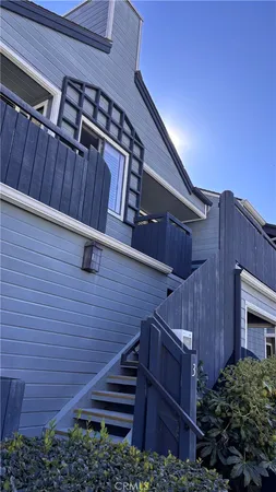 a view of a patio with plants and wooden fence