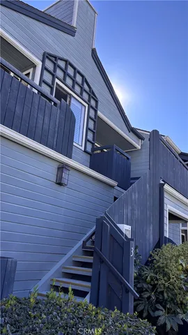 a view of a patio with plants and wooden fence