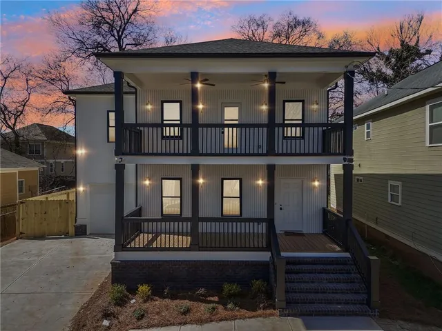 a view of a brick house with many windows