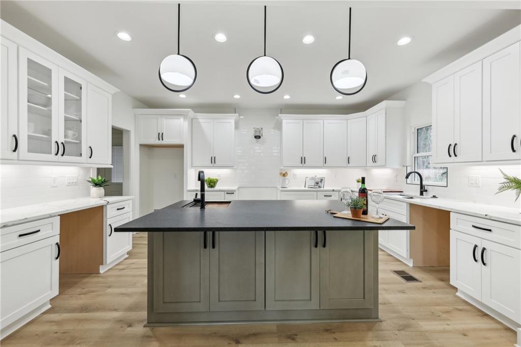 727 Garibaldi Street Southwest Atlanta, GA 30310 - Photo 18 of 84 a kitchen with kitchen island stainless steel appliances a sink and cabinets