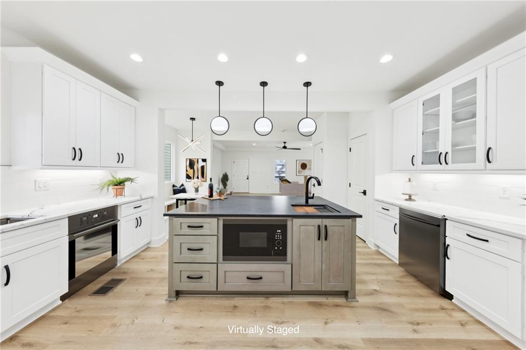 727 Garibaldi Street Southwest Atlanta, GA 30310 - Photo 19 of 84 a kitchen with stainless steel appliances granite countertop a stove and a sink