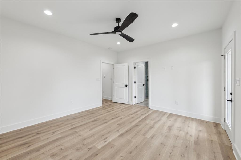 727 Garibaldi Street Southwest Atlanta, GA 30310 - Photo 30 of 84 a view of an empty room with wooden floor and a ceiling fan