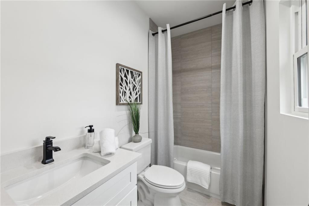 727 Garibaldi Street Southwest Atlanta, GA 30310 - Photo 39 of 84 a bathroom with a sink a toilet and shower