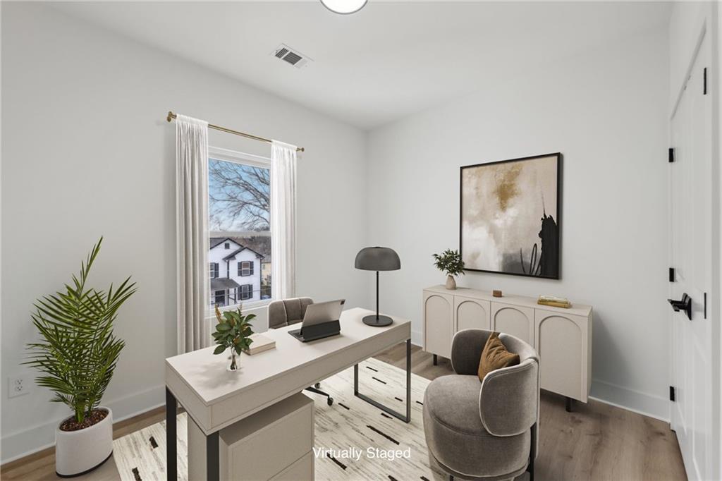 727 Garibaldi Street Southwest Atlanta, GA 30310 - Photo 40 of 84 a living room with furniture a potted plant and a wooden floor