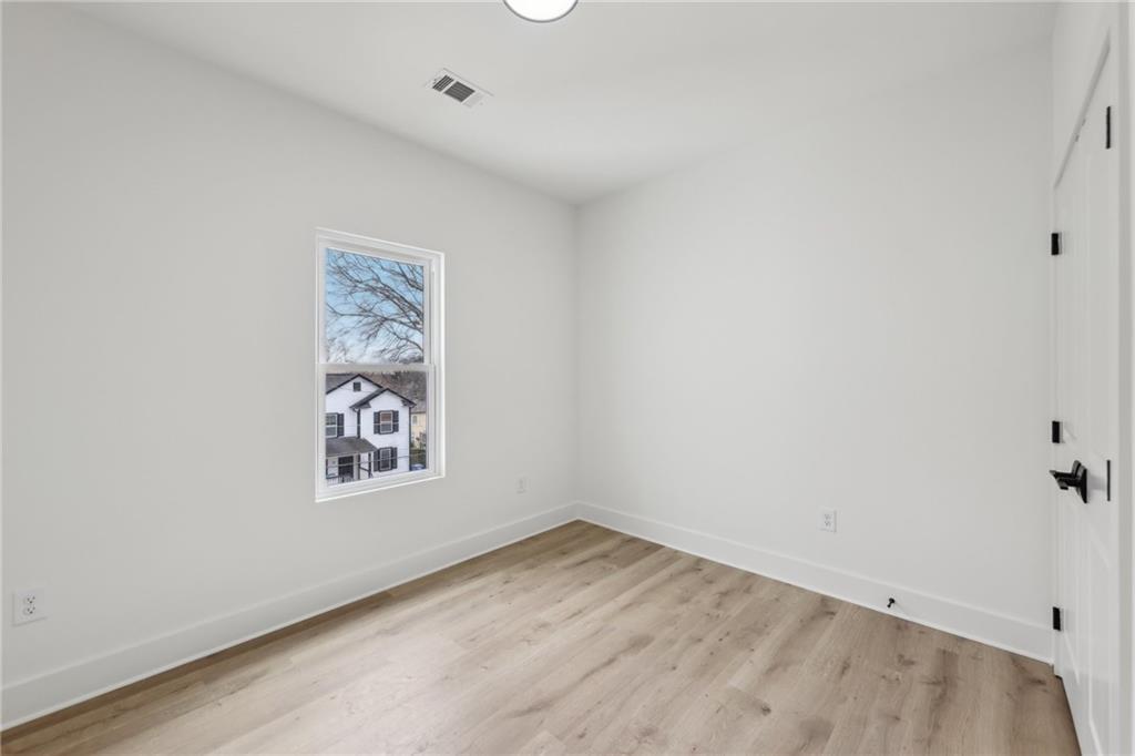 727 Garibaldi Street Southwest Atlanta, GA 30310 - Photo 41 of 84 an empty room with a wooden floor and hallway