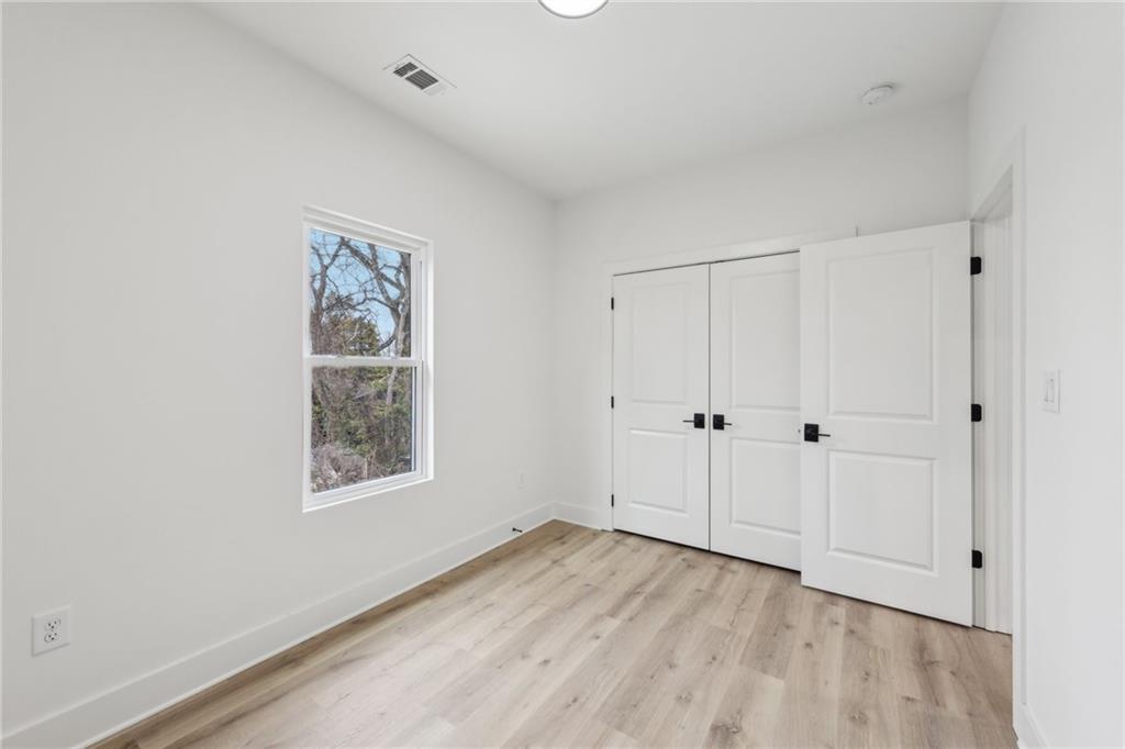 727 Garibaldi Street Southwest Atlanta, GA 30310 - Photo 43 of 84 a view of an empty room with wooden floor and a window