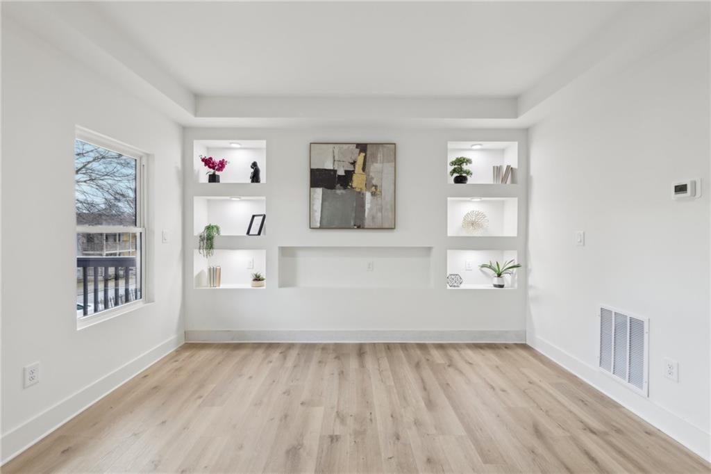 727 Garibaldi Street Southwest Atlanta, GA 30310 - Photo 9 of 84 an empty room with wooden floor and windows
