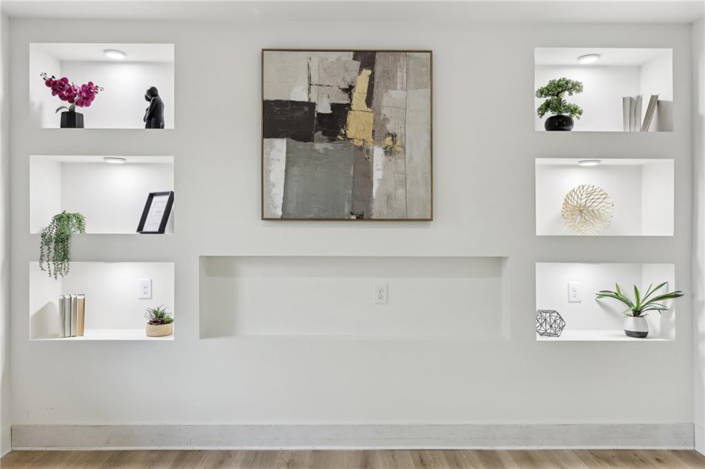 727 Garibaldi Street Southwest Atlanta, GA 30310 - Photo 10 of 84 a picture of a living room with a painting on the wall and a potted plant