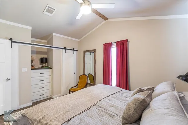 a bedroom with a bed and a walk in closet