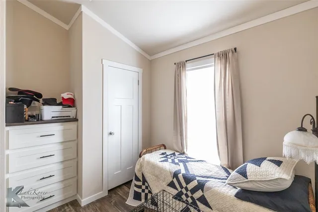 a bedroom with furniture and a window