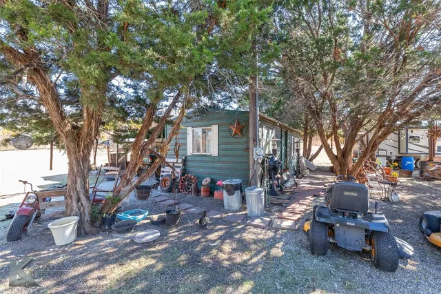 a view of a backyard with large trees