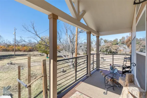 a view of a living room with furniture and floor to ceiling windows