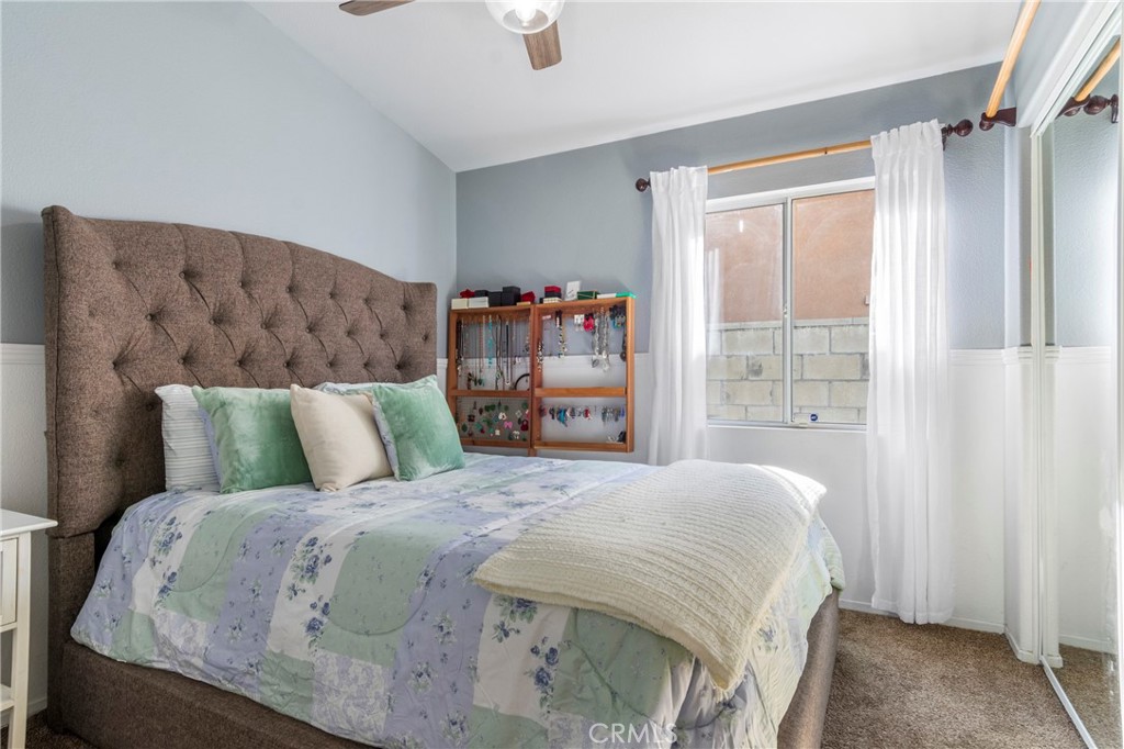 16366 West Sun Canyon Street Riverside, CA 92503 - Photo 16 of 21 a large bed sitting in a bedroom next to a window