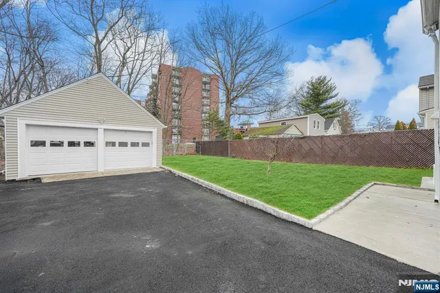 a view of a house with a yard and garage