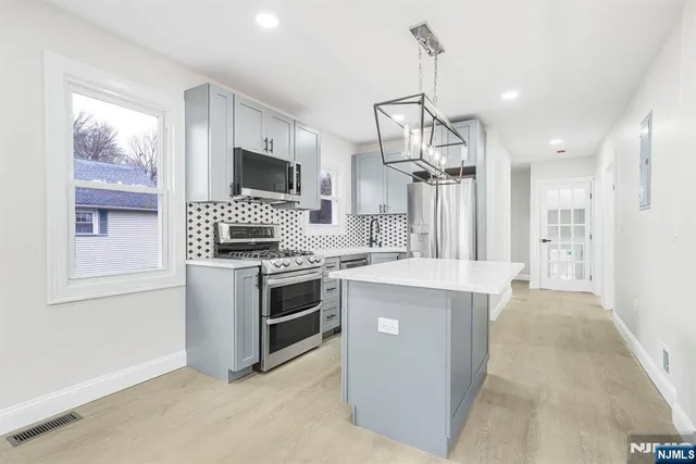 a kitchen that has a lot of cabinets in it