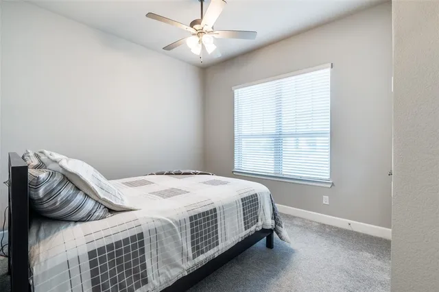 a bed sitting in a bedroom next to a window