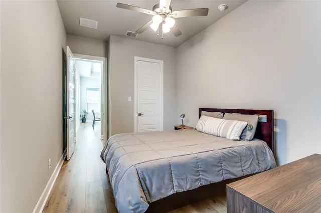 a bedroom with a large bed and a chandelier