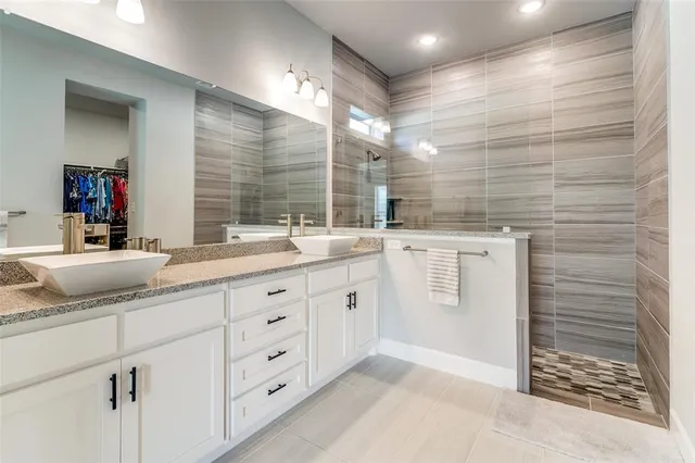 a bathroom with a double vanity sink a and a shower